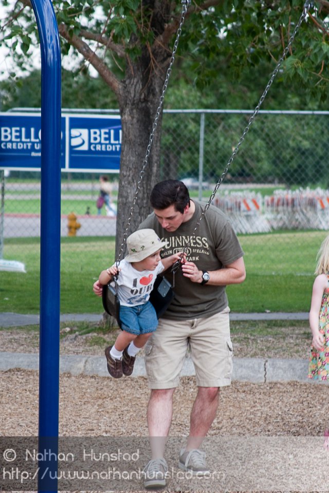Chris and Michael Weber playing on the swings at the Colorado Irish Festival